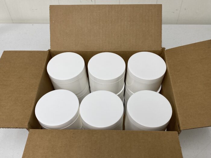 An open carton of white containers